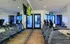 Modern fitness center with multiple treadmills, mirrors, and a view of the outdoor patio, perfect for health enthusiasts.