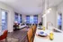 Elegant open-concept living room and kitchen featuring contemporary decor, cozy seating, and chic lighting for a stylish lifestyle.