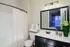 Elegant bathroom with a stylish vanity, large mirror, and soft lighting, creating a serene and inviting atmosphere.