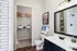Chic bathroom with modern fixtures featuring a spacious walk-in closet, elegant vanity, and contemporary decor.