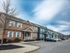Charming suburban townhouse complex with modern architecture and neatly landscaped surroundings in a peaceful neighborhood.