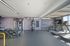 Modern fitness center with state-of-the-art exercise equipment and motivational wall art under sleek lighting.