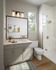 Elegant bathroom with modern fixtures, featuring a sleek vanity, stylish lighting, and a spacious shower area.