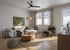 Chic living room with modern furnishings, featuring a cozy sectional sofa, stylish armchair, and elegant decor under natural light.
