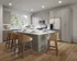 Bright, modern kitchen with spacious island, sleek cabinetry, and stainless steel appliances, perfect for entertaining.