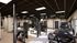 Modern and spacious gym featuring state-of-the-art exercise machines, sleek design, and ample natural light.