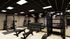 Modern fitness center featuring state-of-the-art weightlifting equipment, sleek design, and ample workout space.