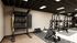 Modern fitness center with state-of-the-art weightlifting equipment, including squat racks, kettlebells, and a punching bag for dynamic workouts.