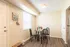 Inviting dining area with a round glass table, cozy seating, and abundant natural light, perfect for intimate meals.