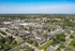 Vibrant aerial view of a charming residential neighborhood with lush greenery, showcasing an inviting community layout and convenient location.