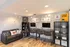 Modern common area with sleek workstations, cozy sofa, and stylish decor in a well-lit setting.