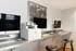 Chic and modern workspace with sleek computers, printer, and stylish bar stools, perfect for productivity.