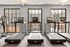 Modern fitness center with state-of-the-art treadmills, large windows offering vibrant city views, and ample natural light.