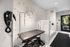 Chic pet grooming station with vibrant dog-themed wallpaper and modern grooming equipment, perfect for pet-friendly living.