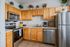 Charming kitchen with modern stainless steel appliances, wooden cabinetry, and warm, inviting decor perfect for culinary creativity.