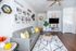 Inviting living room at Maple Ridge Townhomes with modern decor, gray sofa accented with colorful pillows, and a stylish entertainment area with a wall-mounted TV.