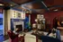 Luxurious living room with a cozy fireplace, elegant decor, plush velvet furniture, and rich wood accents, perfect for relaxation and entertaining.