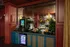 Chic refreshment counter with a modern coffee machine, elegant wall art, and ambient lighting showcasing premium drink selections.