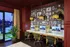 Chic home office space with elegant paneling, vibrant wall art, vintage lighting, and modern workstations overlooking a lush patio.
