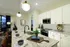 Elegant kitchen with granite countertops, modern appliances, and ambient lighting, perfect for culinary experiences and stylish gatherings.