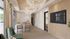 Elegant modern office space with sleek wooden decor, comfortable seating, and stunning glass chandeliers.