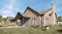 Charming modern bungalow with stone accents and large windows, surrounded by lush greenery and a serene atmosphere.