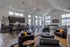 Elegant modern living space with stylish leather seating, open kitchen, and sleek dining area under chic chandeliers.