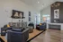 Contemporary living room with cozy seating around a modern fireplace, elegant lighting, and stylish decor, perfect for relaxation.