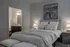 Elegant bedroom with cozy lighting, modern decor, and an ensuite bathroom, perfect for relaxed living.