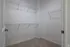 Spacious walk-in closet with clean white walls and modern wire shelving, perfect for organizing your wardrobe.