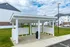 Charming apartment complex with a well-maintained communal mailbox area, featuring modern architecture and lush green surroundings.