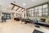 Elegant and spacious living area with modern decor, featuring cozy seating, natural light, and stylish exposed beams.
