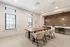 Sophisticated dining area featuring a wooden table, modern upholstered chairs, and a chic accent wall with contemporary lighting.