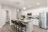 Sleek modern kitchen with a spacious island, stainless steel appliances, and elegant pendant lighting.