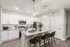 Modern kitchen with sleek granite countertops, stylish cabinetry, and pendant lighting, offering a welcoming and functional space with seating at the island.