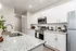 Modern kitchen with sleek granite countertops, stainless steel appliances, and white cabinetry offering a stylish, inviting cooking space.