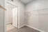 Spacious walk-in closet with ample hanging space and modern design.