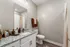 Elegant modern bathroom with granite countertop, sleek fixtures, and warm lighting.