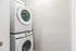 Modern laundry space with sleek stacked Samsung washer and dryer against a neutral backdrop, offering convenience and style.
