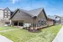 Charming modern apartment building with beautiful architectural design, featuring large windows and well-maintained landscaping.