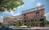 Contemporary multi-story apartment building with stylish brick and modern facade, surrounded by lush trees and urban setting.