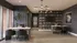 Modern office space with elegant dark furniture, floor-to-ceiling bookshelves, and large windows for natural light.