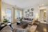 Bright and cozy living room with elegant decor, comfortable seating, and large windows offering inviting natural light.