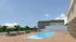 Charming outdoor area featuring a pristine swimming pool, luxurious lounge chairs, and scenic views with clear blue skies.