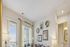Bright and inviting living room with modern decor, natural light through large windows, and elegant sofa arrangement.