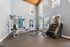 Modern fitness center boasting high ceilings, natural light, and state-of-the-art workout equipment.