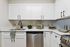 Modern kitchen with sleek white cabinetry, stainless steel appliances, and elegant decor creating an inviting culinary space.