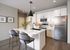 Elegant modern kitchen with sleek white cabinets, stainless steel appliances, and a chic island with stylish seating.