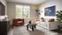 Chic living room with modern decor featuring a plush sofa, stylish armchair, abstract art, and a vibrant indoor plant, bathed in natural light from a large window.