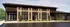 Dynamic exterior view of The Reserve at Mill Run featuring elegant brick facade, modern design, and lush landscaping.